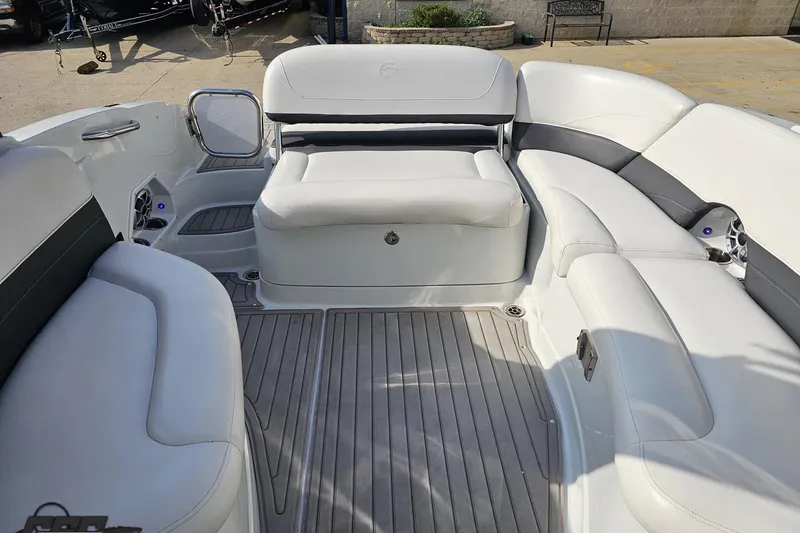 Slide: The Image of 2019 Crownline 275 SS boat interior with white seating and gray flooring. - 107