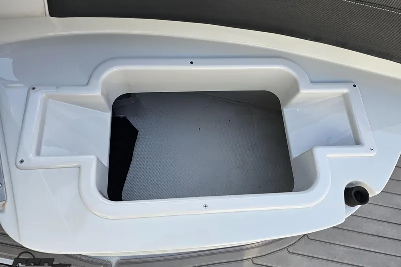 Slide: The Image of 2019 Crownline 275 SS boat storage compartment with white interior and sleek design. - 109