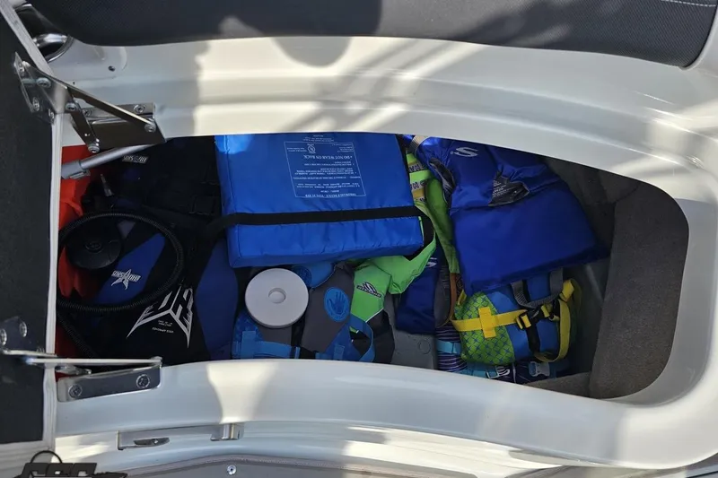 Slide: The Image of Storage compartment of 2019 Crownline 275 SS boat with life jackets and gear. - 111