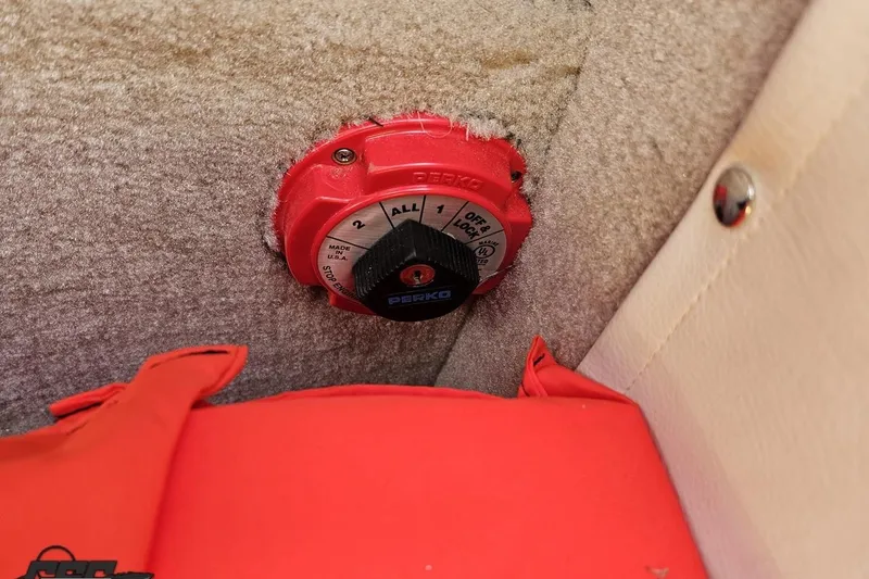 Slide: The Image of Red Perko battery switch in a 2019 Crownline 275 SS boat interior. - 113
