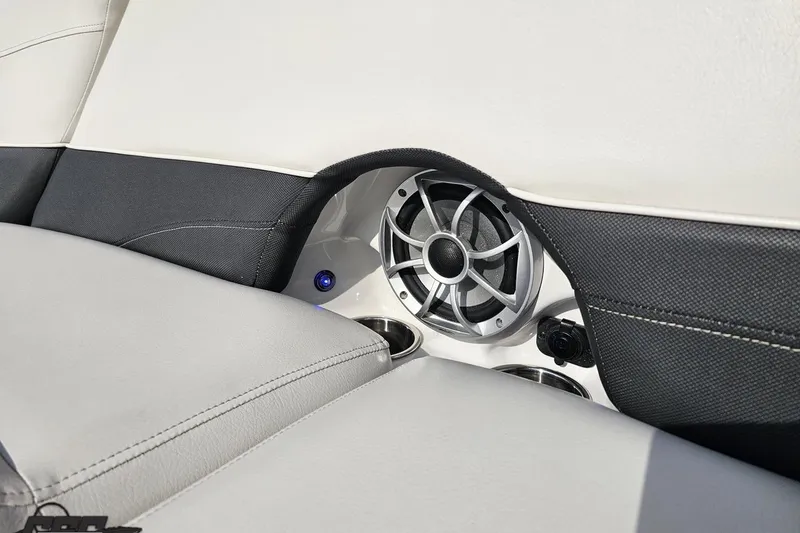 Slide: The Image of Interior of 2019 Crownline 275 SS boat featuring speaker and cup holders. - 114