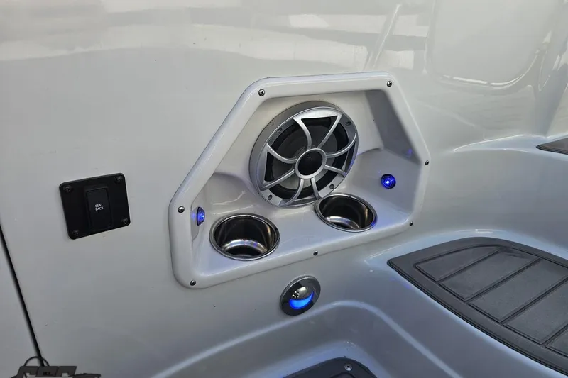 Slide: The Image of 2019 Crownline 275 SS boat interior with speaker and cup holders. - 117