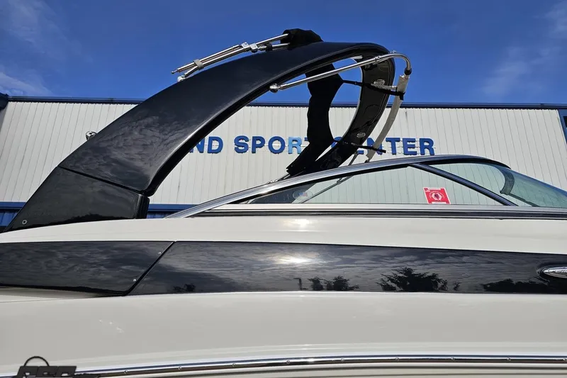 Slide: The Image of 2019 Crownline 275 SS boat with sleek design, displayed at a sports center. - 12