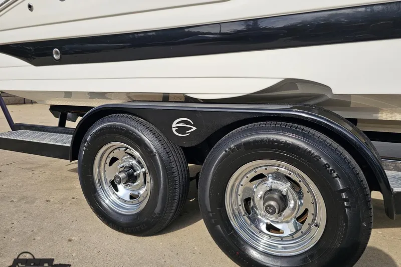 Slide: The Image of 2019 Crownline 275 SS boat on trailer with shiny chrome wheels. - 14