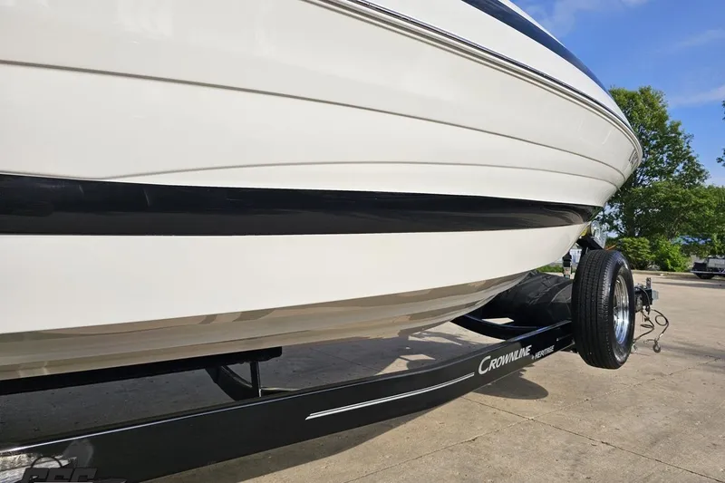 Slide: The Image of 2019 Crownline 275 SS boat on trailer, side view, outdoors. - 15