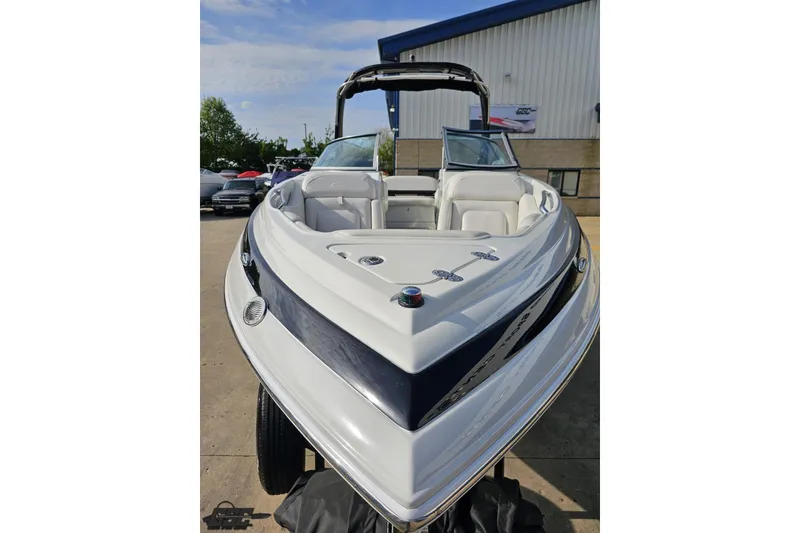 Slide: The Image of 2019 Crownline 275 SS boat with sleek design, parked outdoors near a building. - 20