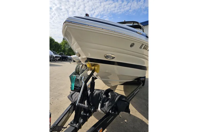 Slide: The Image of 2019 Crownline 275 SS boat on trailer under a partly cloudy sky. - 22