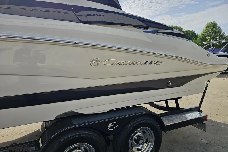 Slide: The Image of 2019 Crownline 275 SS boat on trailer, side view with logo visible. - 29