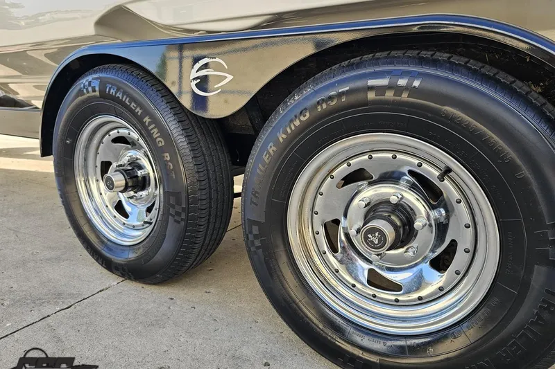 Slide: The Image of Trailer wheels of a 2019 Crownline 275 SS boat, featuring shiny chrome rims. - 34
