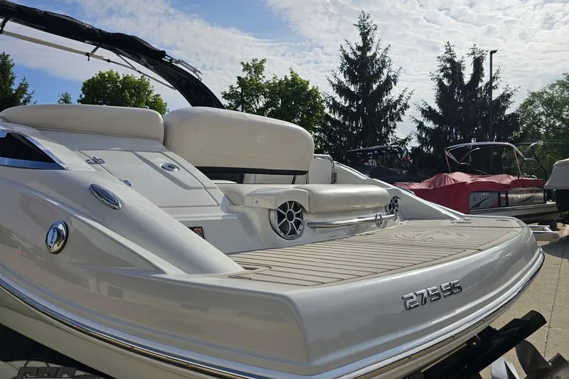 Slide: The Image of 2019 Crownline 275 SS boat with sleek design and spacious seating on a sunny day. - 35