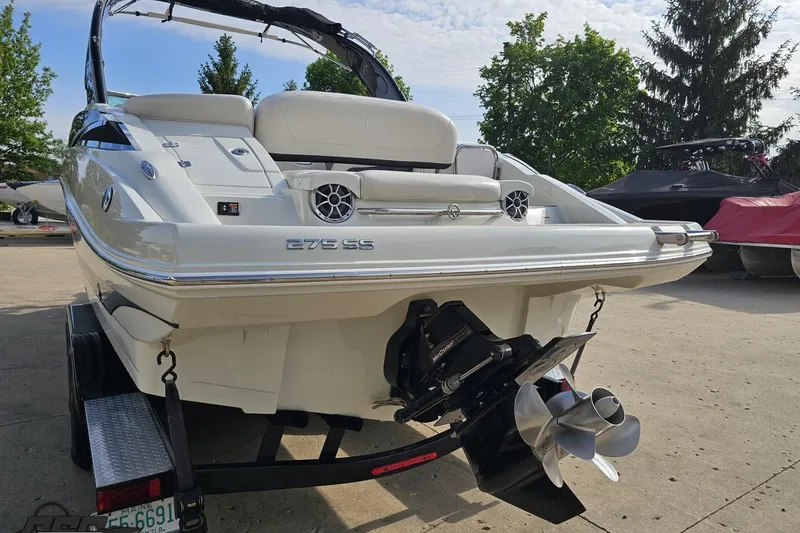 Slide: The Image of 2019 Crownline 275 SS boat on trailer, rear view with dual propellers. - 36