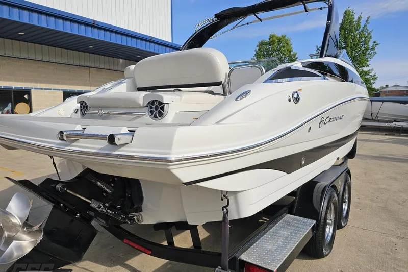 Slide: The Image of 2019 Crownline 275 SS boat on trailer, parked outdoors near a building. - 39