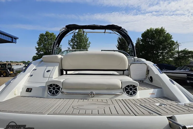 Slide: The Image of 2019 Crownline 275 SS boat with sleek seating and modern design, docked outdoors. - 40