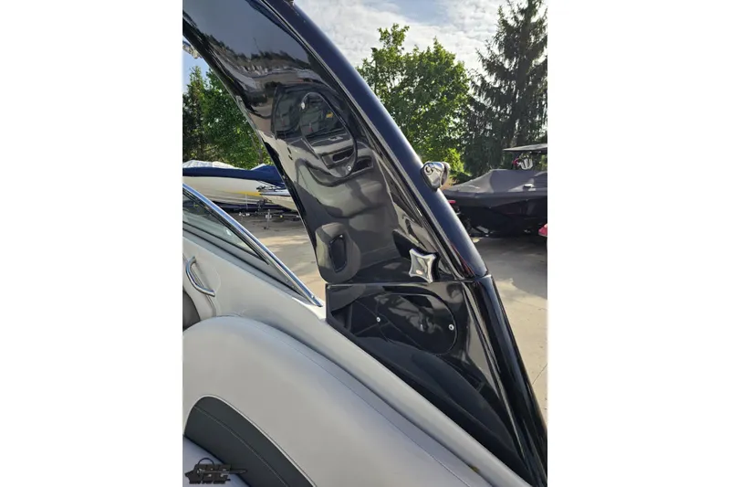Slide: The Image of 2019 Crownline 275 SS boat interior detail with sleek black and gray design. - 60
