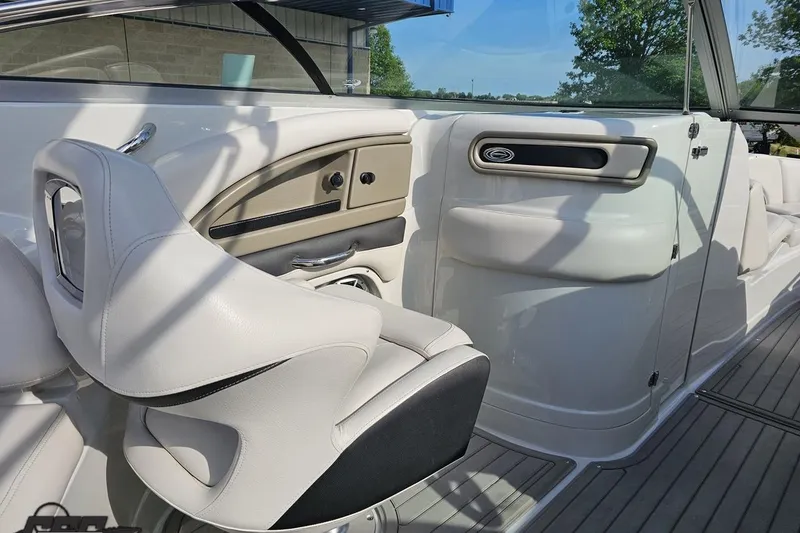 Slide: The Image of 2019 Crownline 275 SS boat interior with white seating and sleek dashboard design. - 65