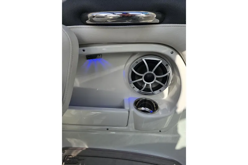 Slide: The Image of Interior of 2019 Crownline 275 SS boat featuring speaker and cup holder. - 69