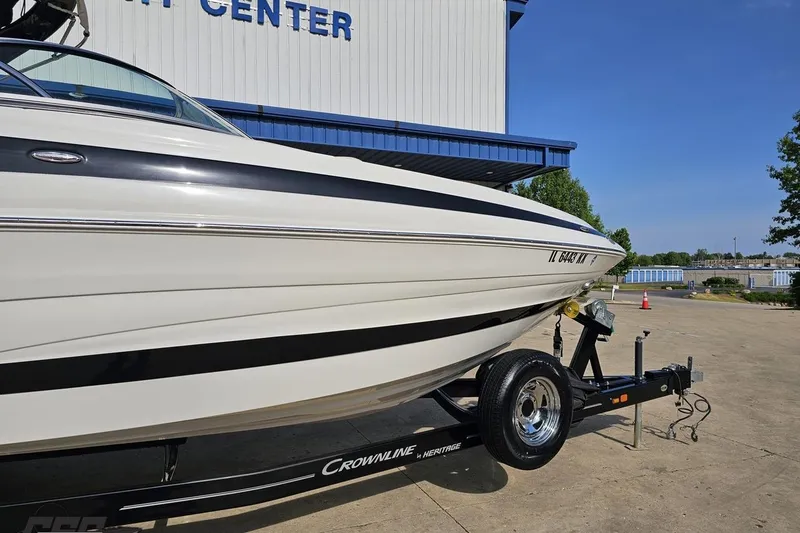 Slide: The Image of 2019 Crownline 275 SS boat on trailer at marina center. - 7