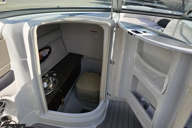 Slide: The Image of 2019 Crownline 275 SS boat interior with sink and storage area. - 70