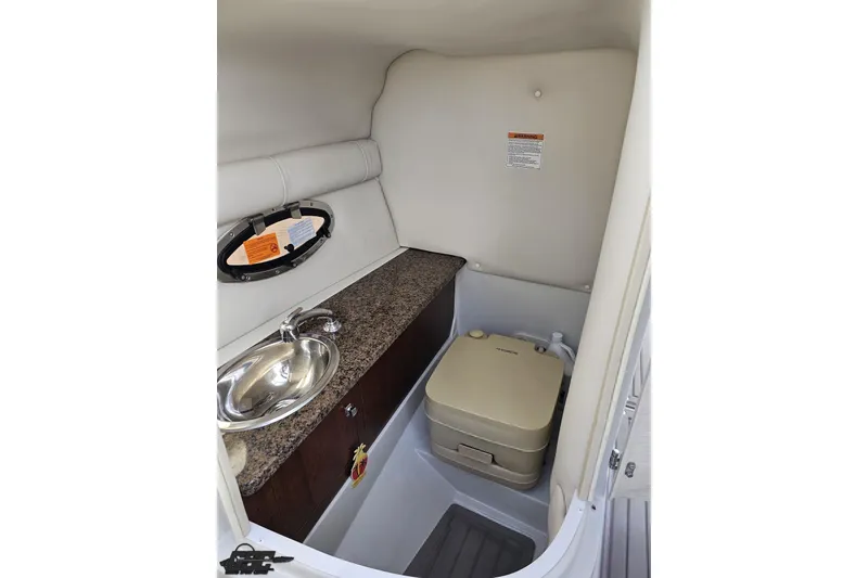 Slide: The Image of 2019 Crownline 275 SS boat interior with sink and portable toilet. - 71