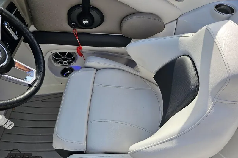 Slide: The Image of 2019 Crownline 275 SS boat interior with steering wheel and cushioned seating. - 72