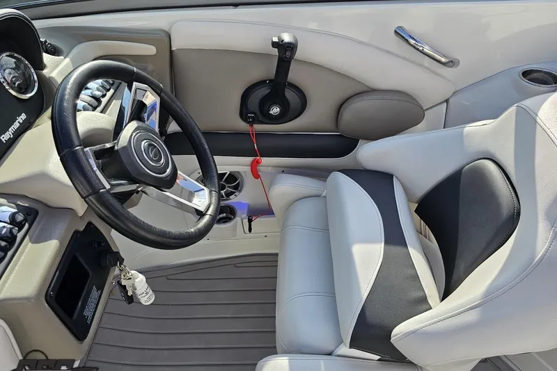 Slide: The Image of 2019 Crownline 275 SS boat interior with steering wheel and seating. - 74
