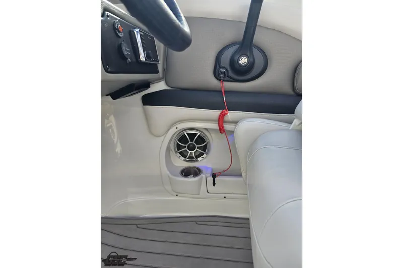 Slide: The Image of Interior of 2019 Crownline 275 SS boat showing steering wheel and speaker system. - 75