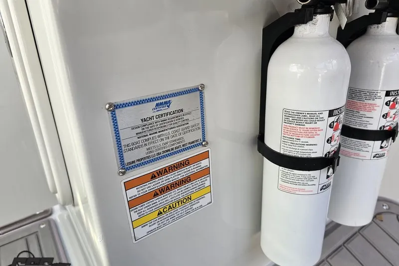 Slide: The Image of Yacht certification and safety warnings on 2019 Crownline 275 SS boat with fire extinguishers. - 76