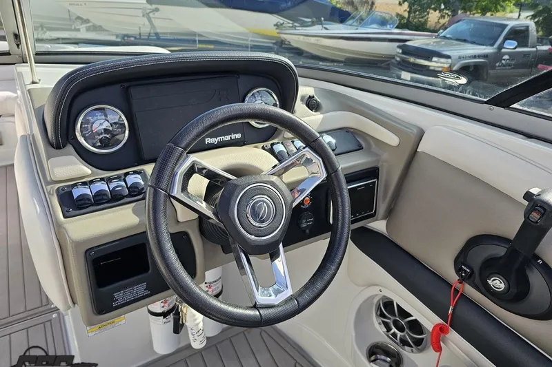 Slide: The Image of 2019 Crownline 275 SS boat dashboard with steering wheel and Raymarine display. - 77