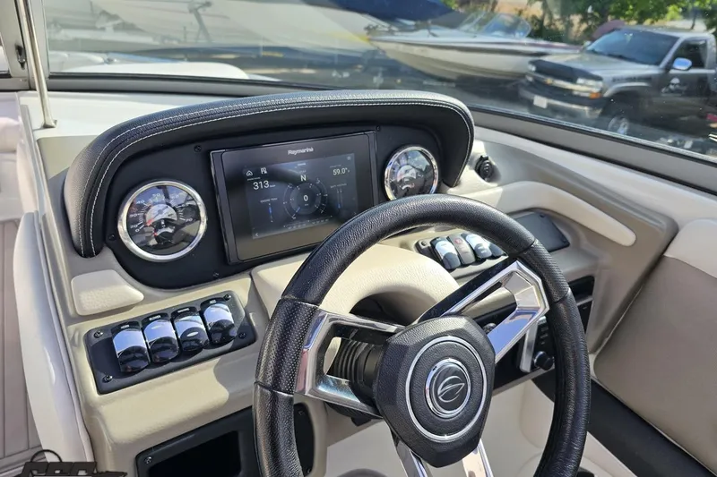Slide: The Image of 2019 Crownline 275 SS dashboard with steering wheel and navigation display. - 80