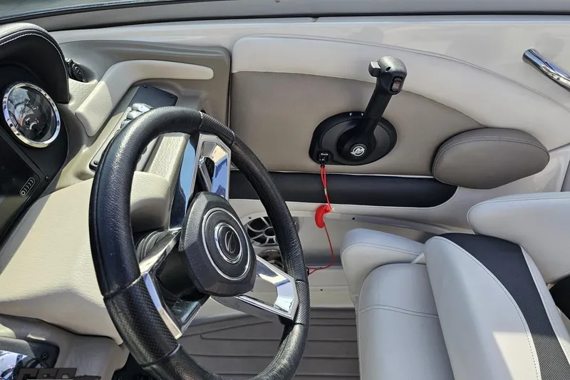 Slide: The Image of Interior view of 2019 Crownline 275 SS boat cockpit with steering wheel and controls. - 81