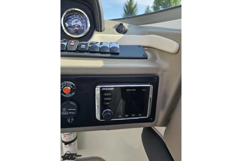 Slide: The Image of Dashboard of a 2019 Crownline 275 SS boat featuring a Kicker media center. - 82