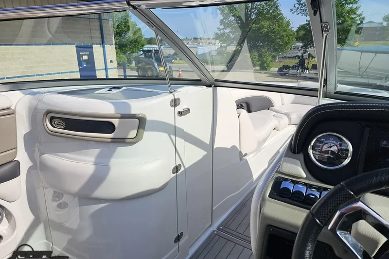 Slide: The Image of 2019 Crownline 275 SS boat interior with dashboard and seating area. - 84