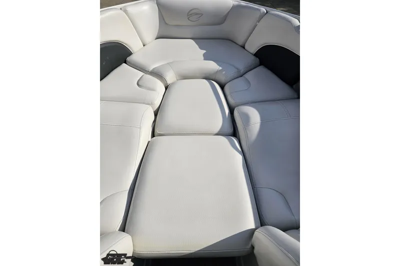 Slide: The Image of 2019 Crownline 275 SS boat interior with white cushioned seating. - 90