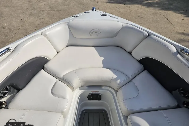 Slide: The Image of 2019 Crownline 275 SS boat interior with white cushioned seating. - 91