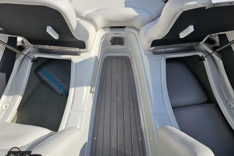 Slide: The Image of Interior view of a 2019 Crownline 275 SS boat, featuring seating and storage areas. - 92