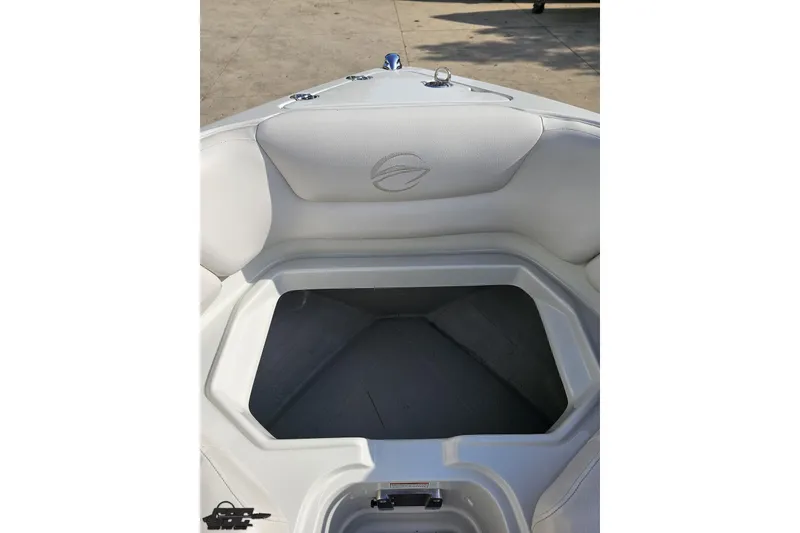 Slide: The Image of 2019 Crownline 275 SS boat interior with white seating and storage compartment. - 94