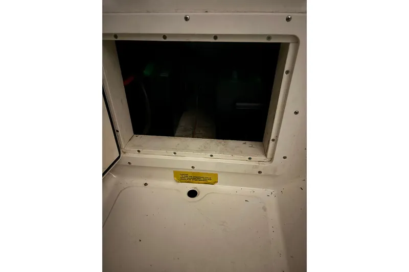 Slide: The Image of 1999 Pursuit 2460 Denali boat interior compartment with access panel. - 10