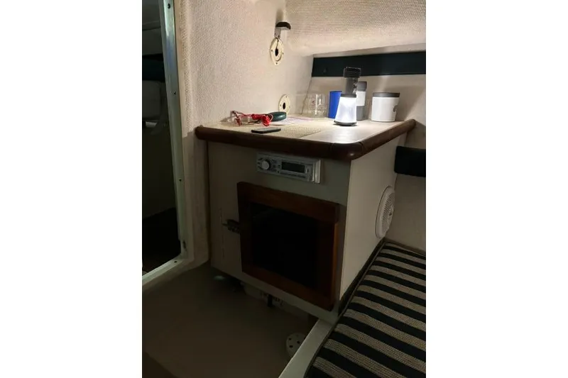 Slide: The Image of Interior cabin of a 1999 Pursuit 2460 Denali boat with storage and seating. - 6