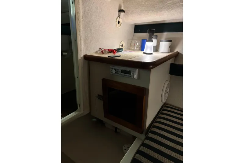 Slide: The Image of Interior cabin of a 1999 Pursuit 2460 Denali boat with storage and lighting. - 9