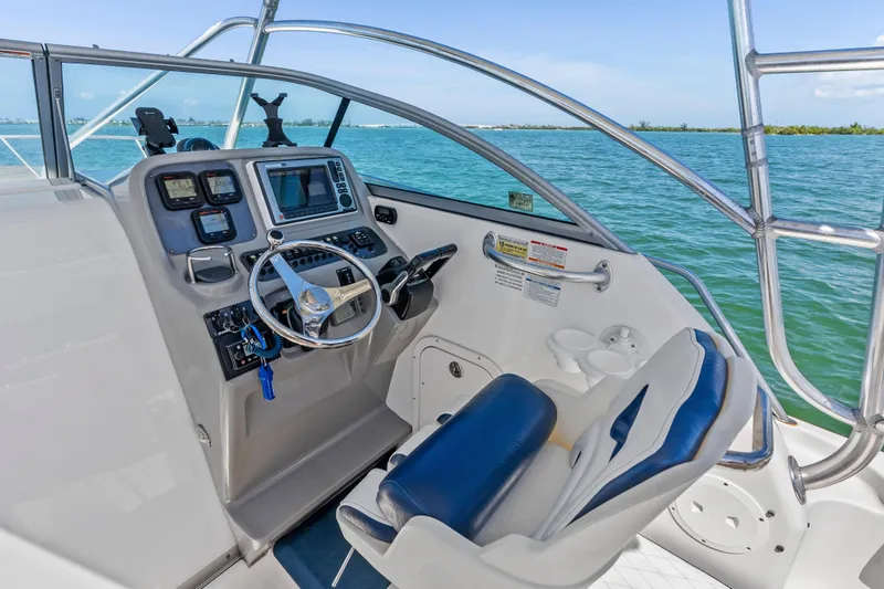 Slide: The Image of 2009 Robalo R245 Walkaround boat cockpit with steering wheel and navigation instruments. - 13