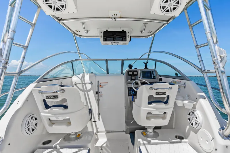 Slide: The Image of 2009 Robalo R245 Walkaround boat cockpit with dual seats and navigation equipment. - 16