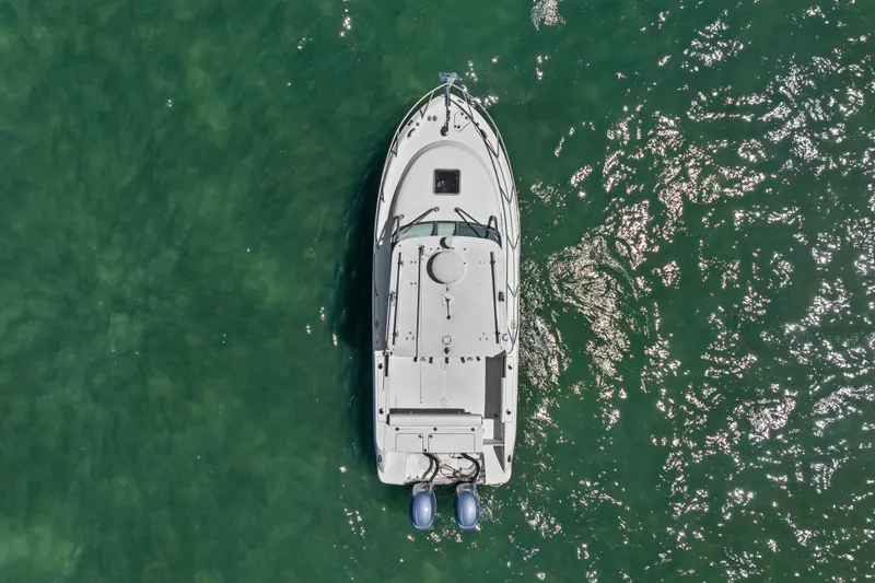 Slide: The Image of Overhead view of 2009 Robalo R245 Walkaround boat on shimmering green water. - 5