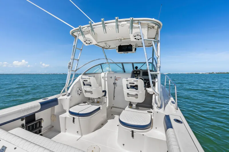 Slide: The Image of 2009 Robalo R245 Walkaround boat interior with dual seats, ocean view, and clear blue sky. - 9