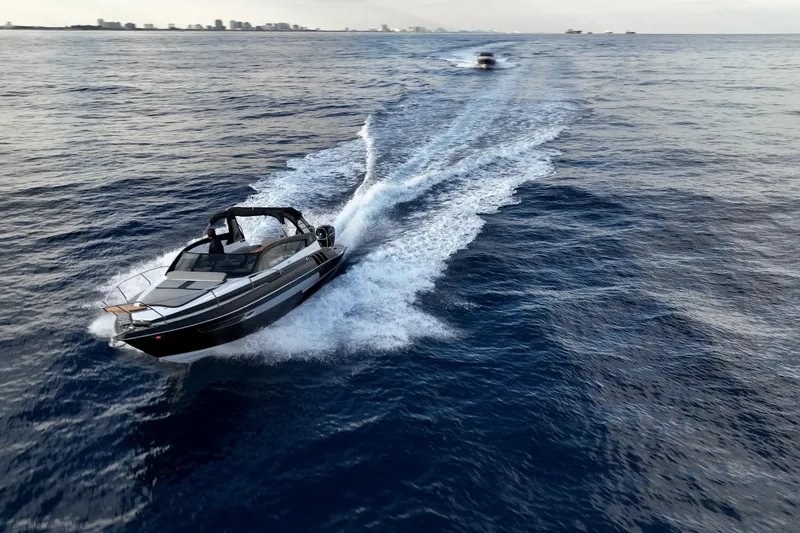 Slide: The Image of 2027 Hanover 305 boat cruising on open water, leaving a wake behind. - 11