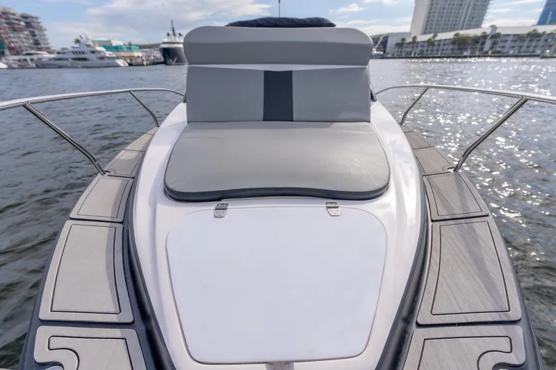 Slide: The Image of Luxurious Hanover 305 yacht deck with cushioned seating, docked in a marina, 2027 model. - 13