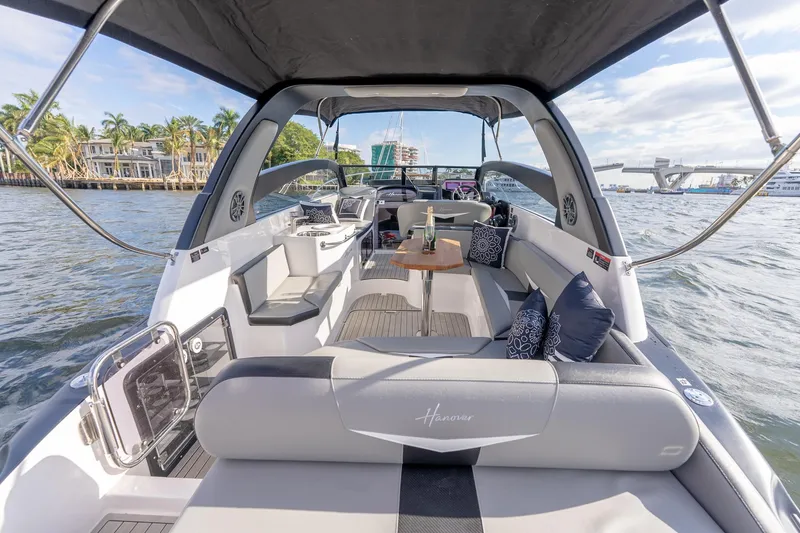 Slide: The Image of Luxurious 2027 Hanover 305 yacht interior with elegant seating and scenic waterfront view. - 14