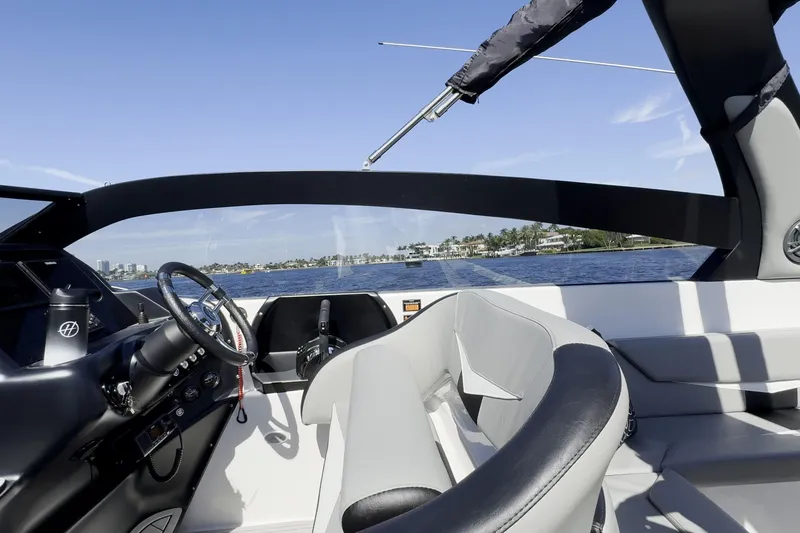 Slide: The Image of Interior view of a 2027 Hanover 305 boat with steering wheel and seating. - 16