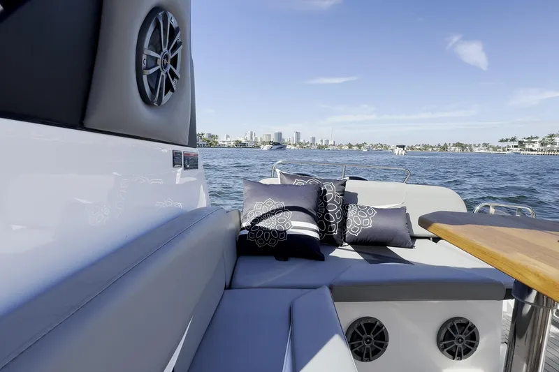 Slide: The Image of Luxurious Hanover 305 boat interior with cushions, overlooking a scenic waterfront view. - 19