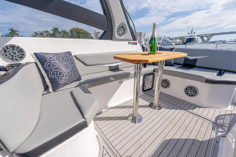 Slide: The Image of Luxurious Hanover 305 yacht interior with seating, table, and champagne, 2027 model. - 22