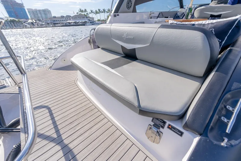 Slide: The Image of Luxurious seating on a 2027 Hanover 305 yacht, docked by a scenic waterfront. - 27